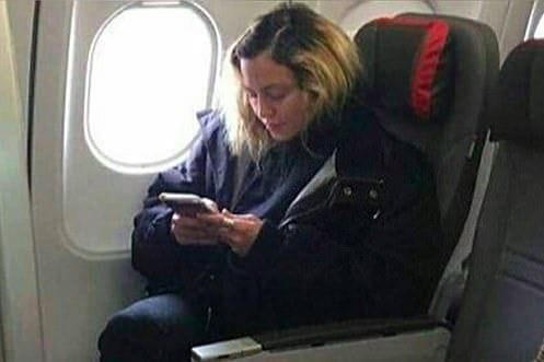 This 'normal' airplane passenger is actually a world famous singer! Do you see who it is?