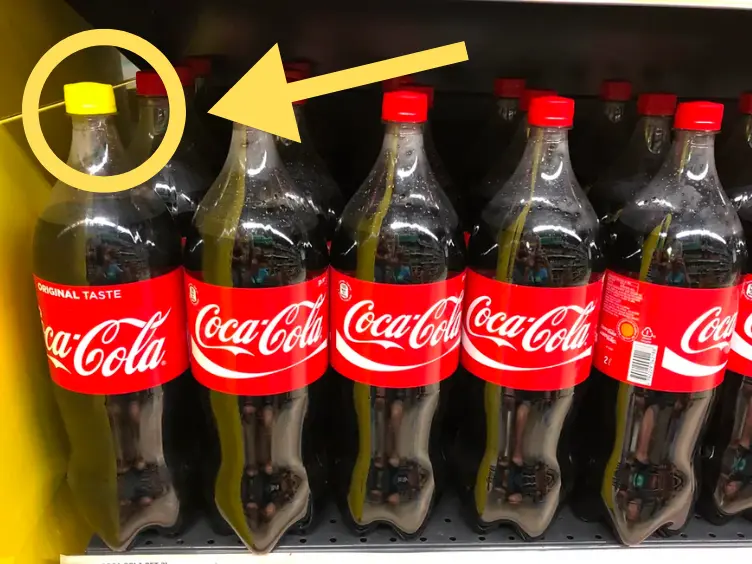 Waarom Coca-Cola Flessen Opeens Gele Doppen Hebben